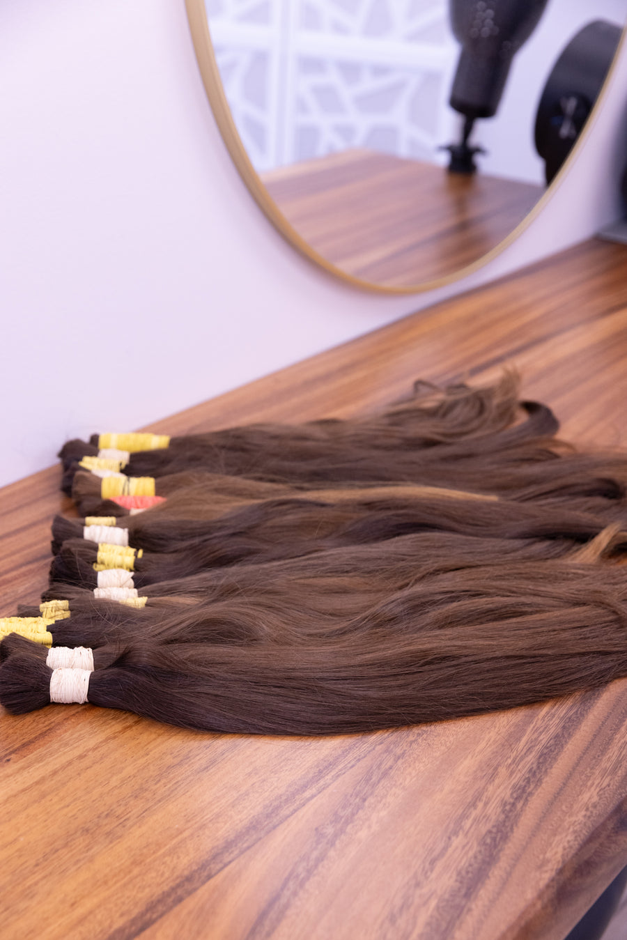 Raw hair bundles tied and labeled before grading at the bench
