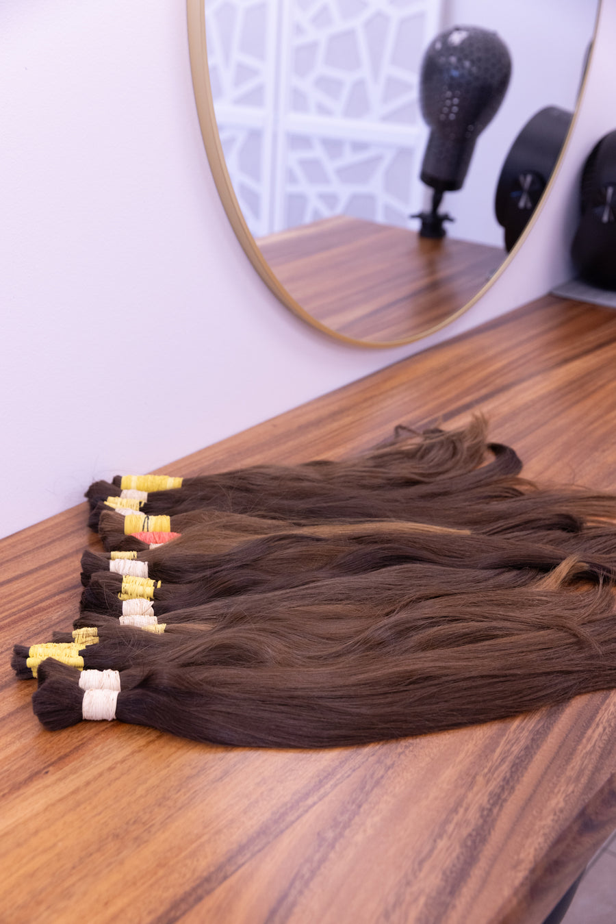Raw European hair bundles on the workbench, ready for wholesale dispatch