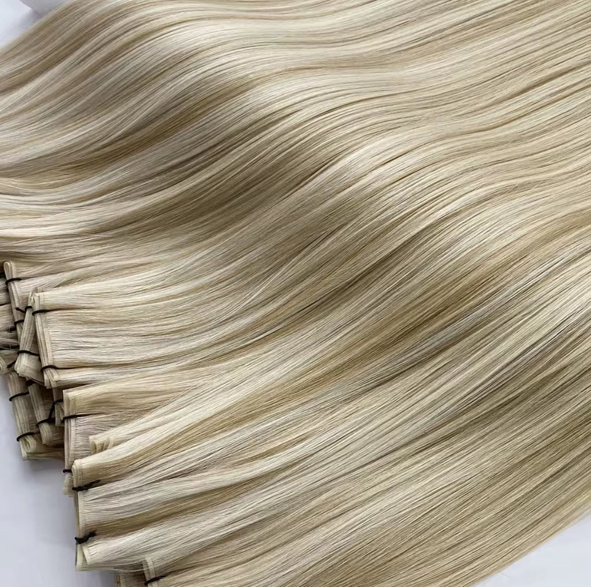 Folded machine weft bundles in soft blonde waves — wholesale European hair